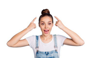 Portrait of impressed girl pointing at her haircut with index finger screaming wearing white t-shirt denim jeans overalls isolated over blue background