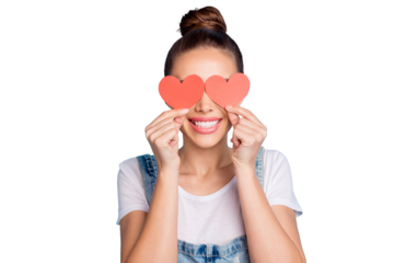 Close up photo of lovely girl hiding her eyes with paper card heart wearing white t-shirt denim jeans overalls isolated over blue background