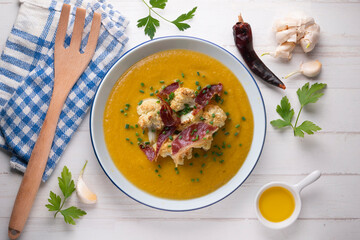 Pumpkin and cauliflower cream with crispy ham. Top view table.