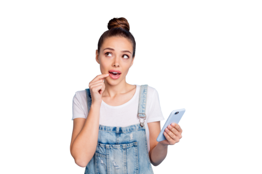 Photo of thinking pondering pensive planning charming cute girl holding phone with hand contemplating something while isolated with blue background