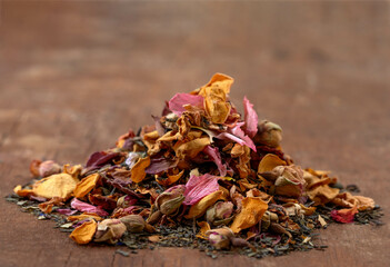Dried flower petals and herbs arranged on wood