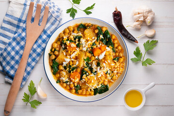 Spinach, potato and chickpea stew with egg. Top view table.