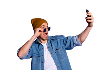 Photo of shouting attractive handsome holding telephone with hands taking selfie wearing brown cap isolated over vibrant color purple background