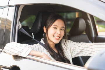 Transport concept, happy smile brunette hair asian young woman driving, getting new car, vehicle for travel, trip with face positive, female driver car with fasten safety seat belt before traveling.