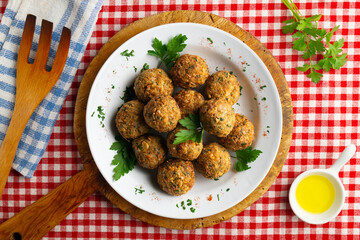 Fried chickpea falafel balls with parsley sprigs.