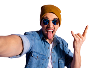 Self photo of cheerful mad crazy rock fan showing rock sign horned fingers sticking tongue out wearing jeans denim jacket isolated over purple vibrant background