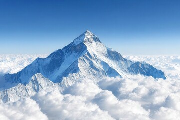 Majestic view of snow-covered mountain peak surrounded by clouds against a clear blue sky