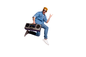 Full length body size photo of trendy style stylish crazy funny funky screaming guy wearing jeans denim jacket showing you horned fingers sign with recorder isolated purple vivid color background
