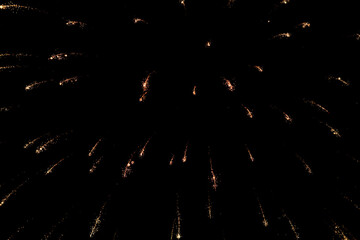 Spectacular golden fireworks show in night sky, shining sparks and trails perfect for celebration and backgrounds
