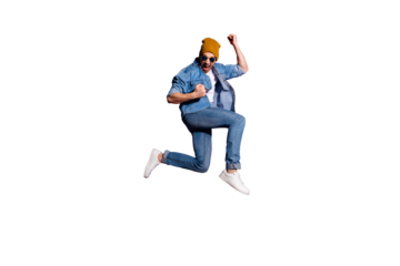 Full length body size photo of cheerful ecstatic screaming guy wearing jeans denim jacket overjoyed with victorious glory jumping up brown cap isolated over purple vivid color background