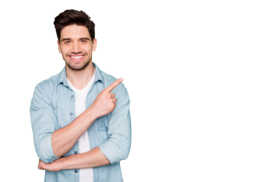 Photo of positive cheerful attractive handsome man pointing at empty space with forefinger smiling toothily with bristle isolated over green color vivid background