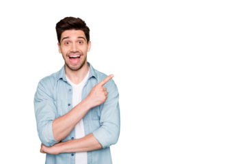 Photo of cheerful positive brown haired cute man pointing at empty space expressing shocked emotions excited ecstatic isolated over green vivid color background