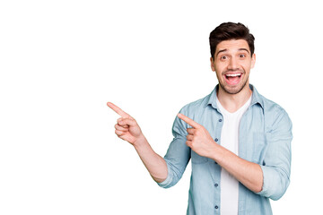 Photo of cheerful positive handsome man pointing at empty space expressing ecstatic emotions on...