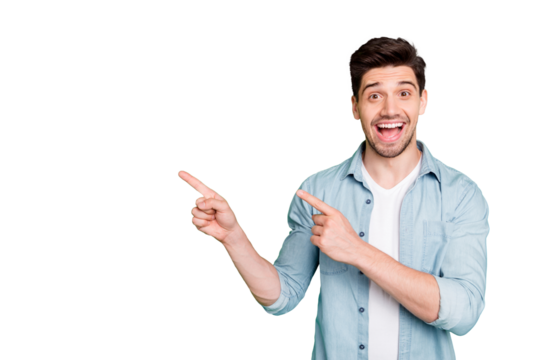 Photo of cheerful positive handsome man pointing at empty space expressing ecstatic emotions on face with bristle isolated over green vivid color background