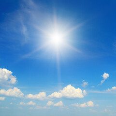 Blue sky with white clouds and sun.