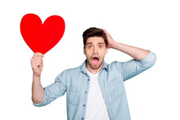 Photo of amazing guy holding big red paper heart forgot about romance surprise for girlfriend open mouth wear denim shirt isolated green color background