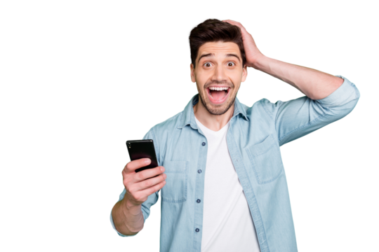 Photo of cheerful brunet haired excited crazy casual man holding telephone rejoicing with feednews read just shouting with ecstatic emotions isolated over green vivid color background