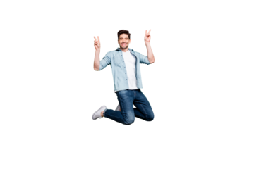 Full length body size photo of kind friendly cheerful man showing you double v-sign greeting you isolated over green vivid color background while jumping up
