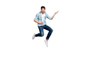 Full length body size photo of cheerful positive ecstatic overjoyed man pretending to be playing guitar wearing white sneakers jumping like rocker on stage isolated over green vivid color background