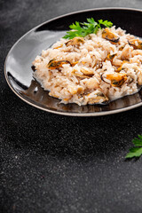 Rice seafood risotto mussels, shrimp, prawn, rapan, squid vegetable dish fresh gourmet food background on the table rustic food top view copy space