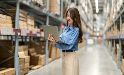 Female engineer is handling shipping and checking stock inventory in the warehouse with a laptop, industry, import-export, inventory management, logistics, global transportation at warehouse, business