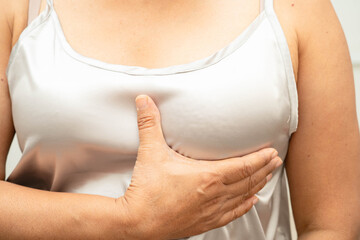 Asian woman self touching check lump or Breast cancer, Breast Self Exam.
