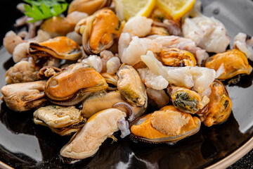 Seafood mix frut de mer mussels, shrimp, prawn, rapan, squid dish fresh gourmet food background on the table rustic food top view copy space keto  paleo diet vegetarian pescetarian diet