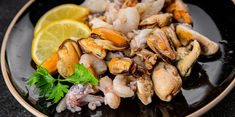 Seafood mix frut de mer mussels, shrimp, prawn, rapan, squid dish fresh gourmet food background on the table rustic food top view copy space keto  paleo diet vegetarian pescetarian diet