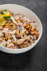 Seafood mix frut de mer mussels, shrimp, prawn, rapan, squid dish fresh gourmet food background on the table rustic food top view copy space keto  paleo diet vegetarian pescetarian diet