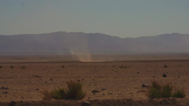 A dust devil blowing across the barren desert