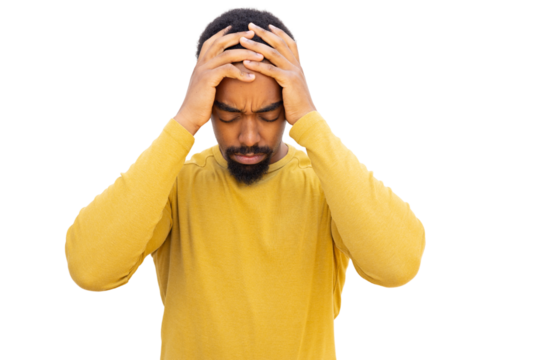 Young man with beard wearing yellow sweater is having a bad headache and holding his head with hands