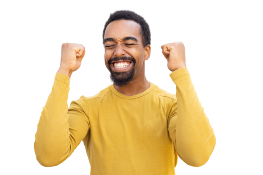Victorious male celebrating, pumping fists high with jubilant emotion against clear backdrop