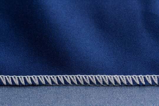Close up of overlock seam on a blue cloth