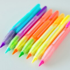 Set of colorful gel pens arranged in row featuring bright neon shades for artistic use