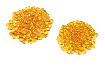 A group of yellow capsules isolated on a white background.