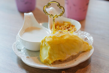 Thai dessert durian with coconut milk and sticky rice.