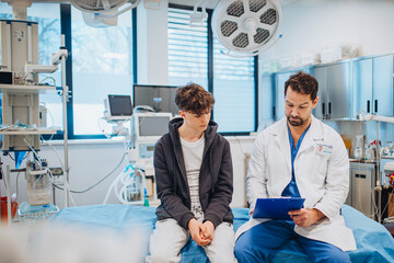Empathetic doctor supporting teenage patient during health consultation.
