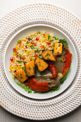Dish with baked salmon, peppers and couscous salad. Top view table.