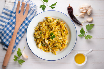Cod o bras, golden cod with potatoes, a traditional Portuguese dish. Top view table.