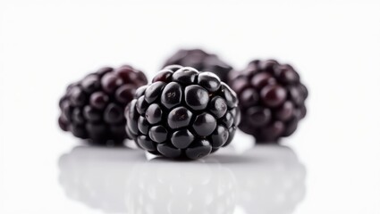 The Jewel of the Bramble: A Cluster of Fresh Blackberries Radiating on a White Surface, Evoking a Sense of Natural Sweetness and Summer Abundance