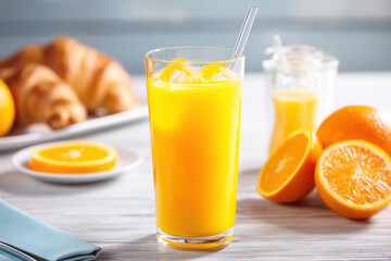 Refreshing orange juice with croissants: a bright and delicious morning treat on a wooden table