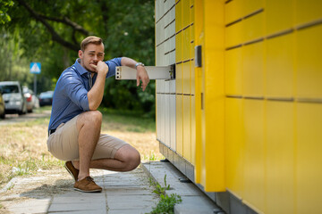 A Casual Young Man Posing Effortlessly Near a Bright Yellow Wall in an Urban Setting