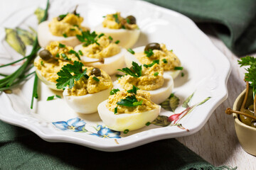 Eggs stuffed with mousse of egg yolk, mayonnaise, mustard and capers.