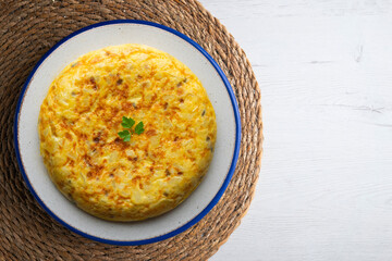 Spanish omelette with potatoes and onion. Top view table.