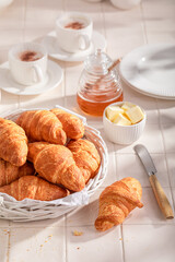 Homemade and fresh french croissants with honey and butter.