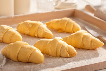 Delicious french croissants prepared on pastry board.