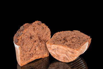 Chocolate muffins with chocolate pieces, close-up, isolated on black background.