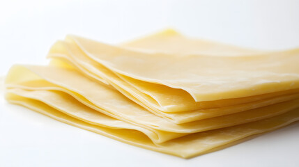 A simple arrangement of lasagna sheets laid flat with slight overlapping on a white background, emphasizing their smooth texture and thinness.