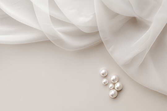 Minimal elegant wedding background with flowing white sheer fabric and scattered pearls on beige surface, luxury and romantic theme, ideal for bridal invitations, jewelry branding, or beauty concepts