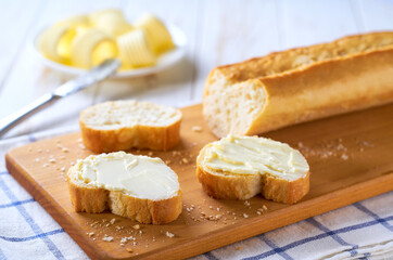 French baguette with butter, concept for breakfast.